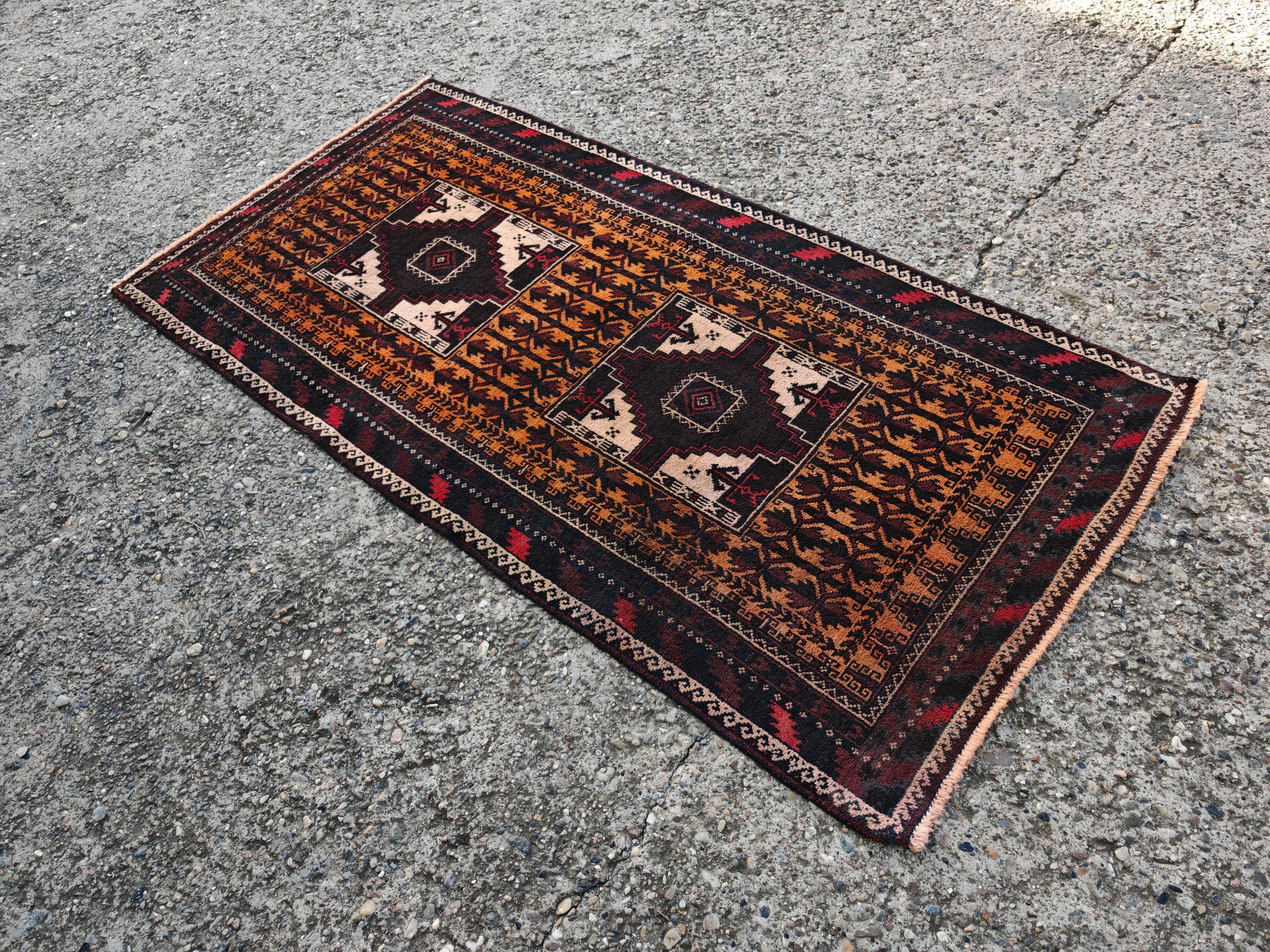 Vintage Persian Baluch rug, hand-knotted wool, 1970.