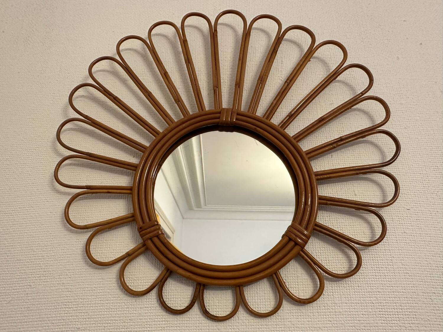Old vintage asymmetrical round rattan mirror