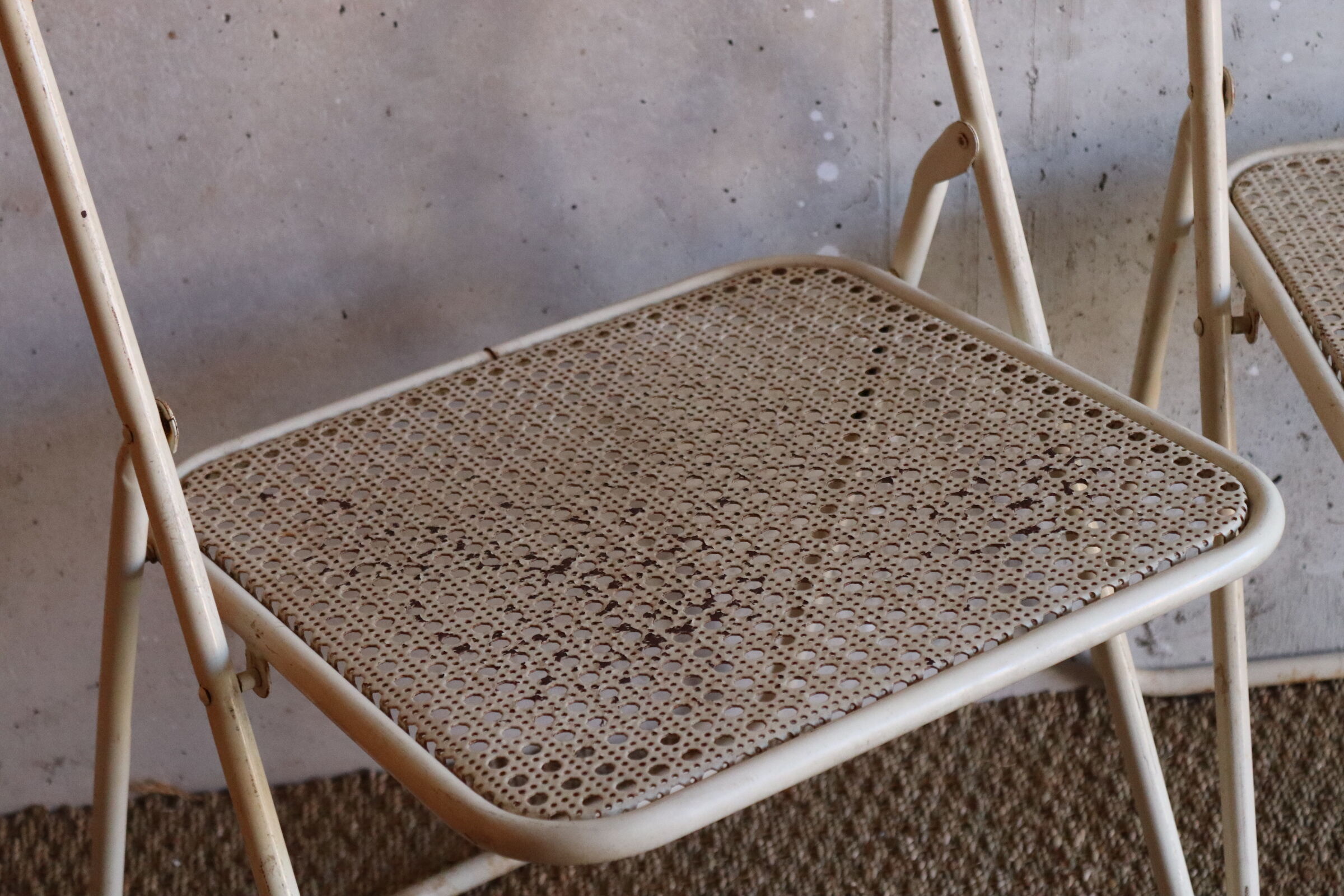 Two metal tanned folding chairs