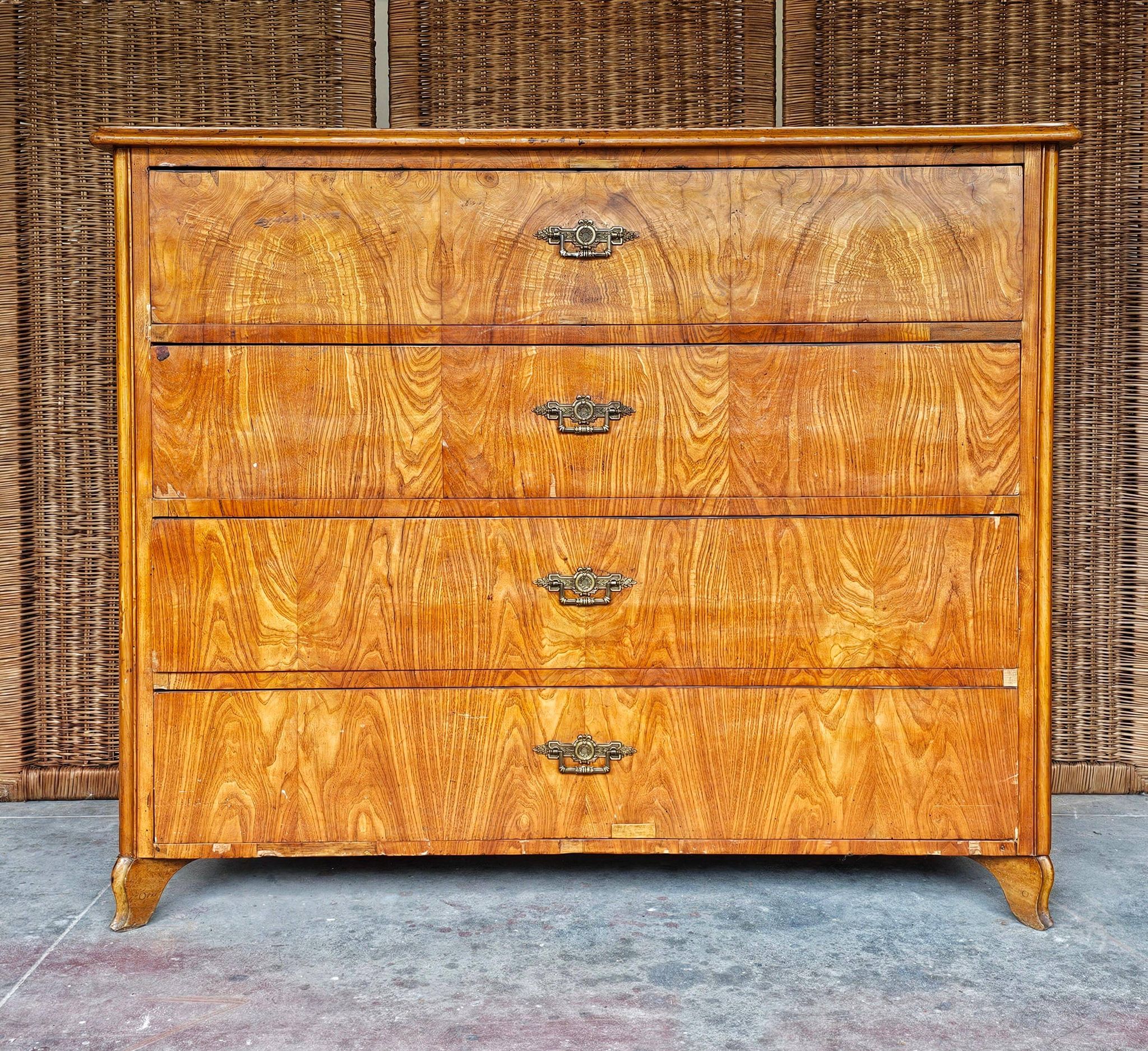 Large antique Biedermeier-style chest of drawers with wood grain.