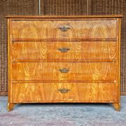 Large antique Biedermeier-style chest of drawers with wood grain.