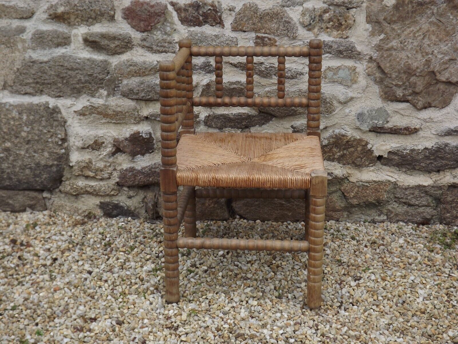 French antique turned wooden bobbin chair with rush seat