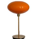 Table lamp with a vintage orange glass globe saucer and a gold base