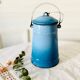 Old vintage milk jug in degraded blue enameled sheet metal