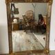 Large Deknudt mirror in gilded wood and glazing beads