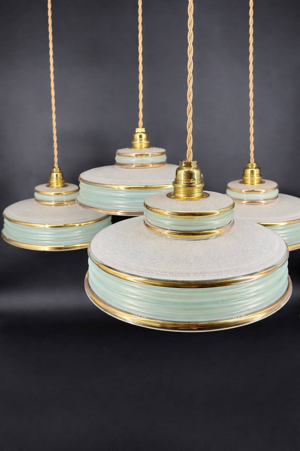 Set of 4 Art Deco pendant lights in frosted water green and gold.