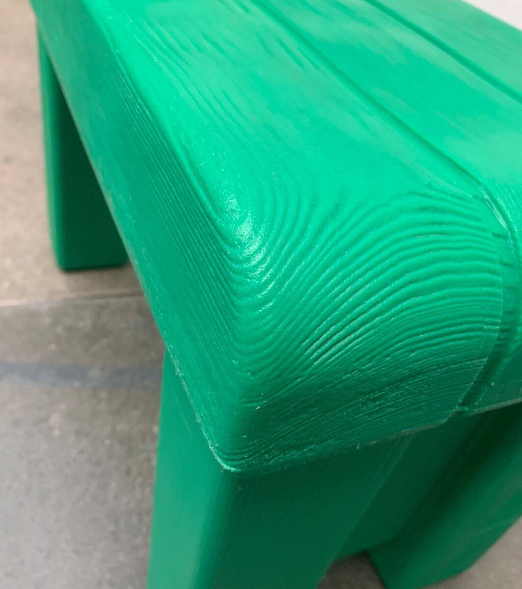 Postmodern plastic stool with a wood effect.