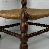 Brutalist wood turned bobbin low rush chair in the style of Charles Dudouyt
