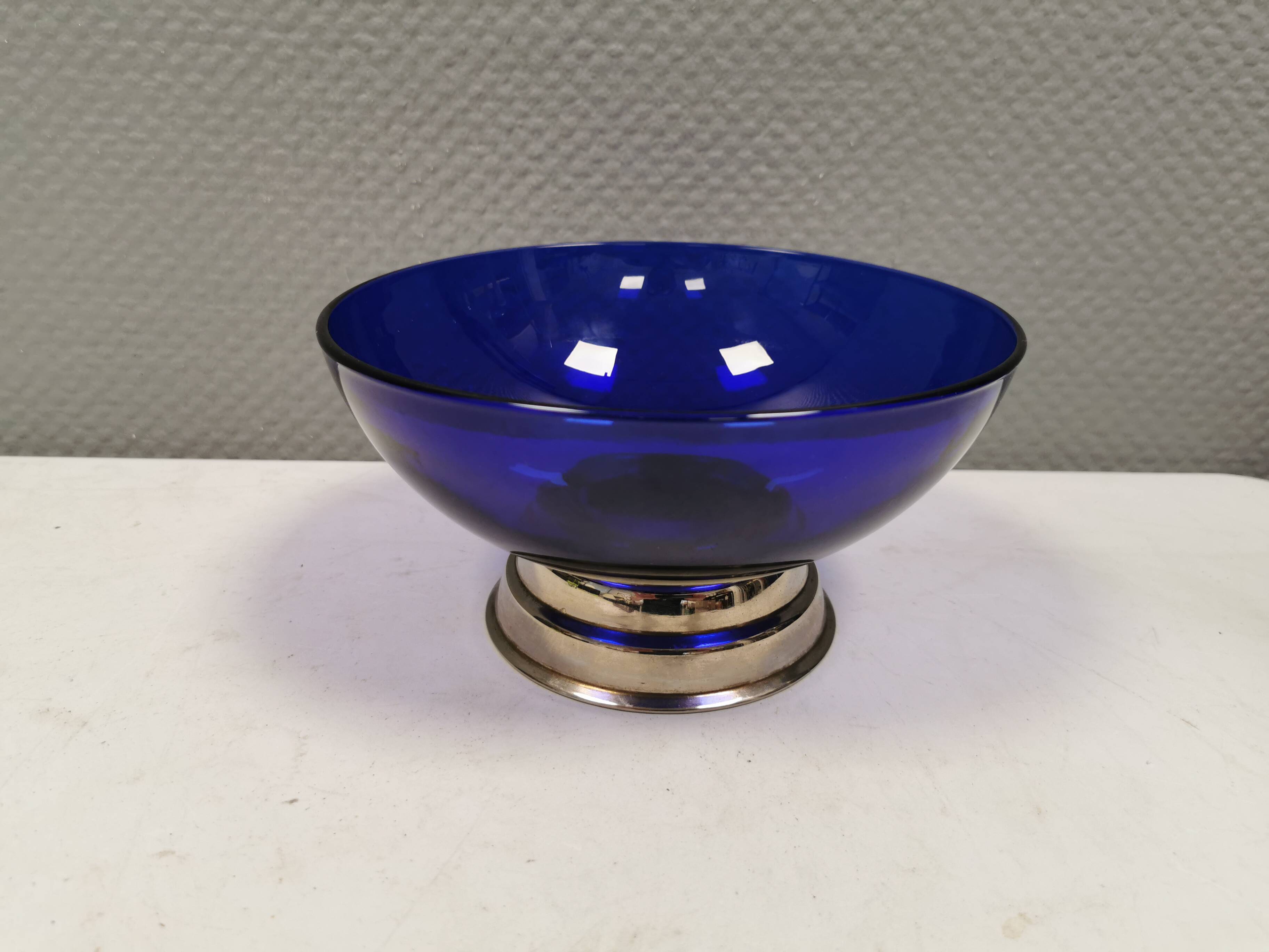Beautiful blue glass bowl mounted on silver colored base (Original).