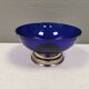Beautiful blue glass bowl mounted on silver colored base (Original).
