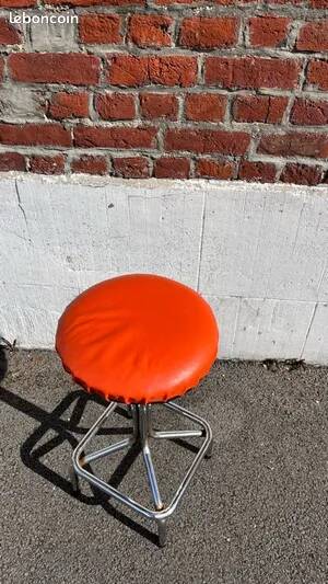 Vintage chrome stool with orange faux leather.