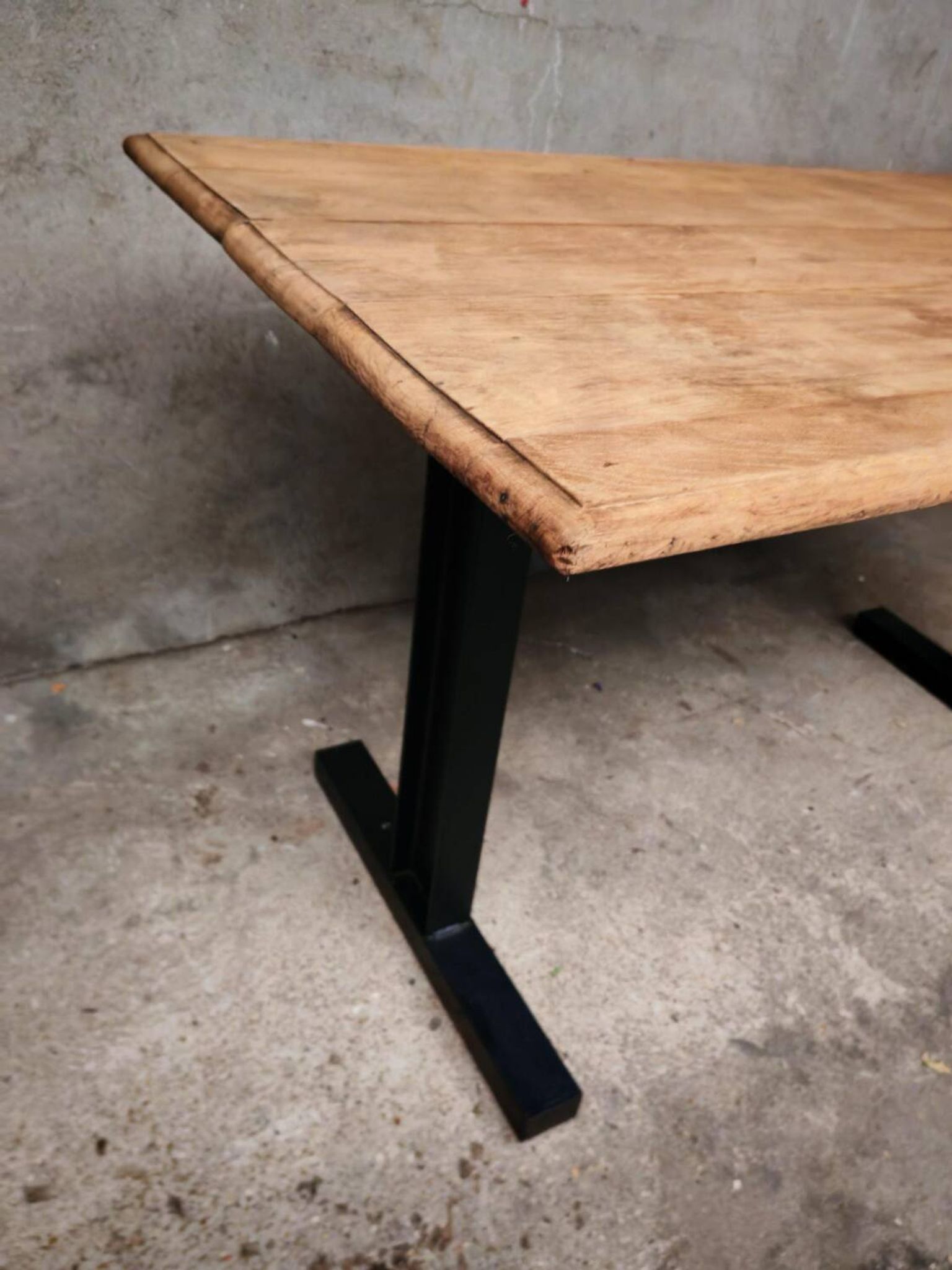 Unique wooden table with metal industrial legs.