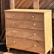 Large antique English chest of drawers in raw solid oak.