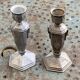 Pair of metal candlesticks, chiseled with a statuette in front, rose pattern in relief, art deco