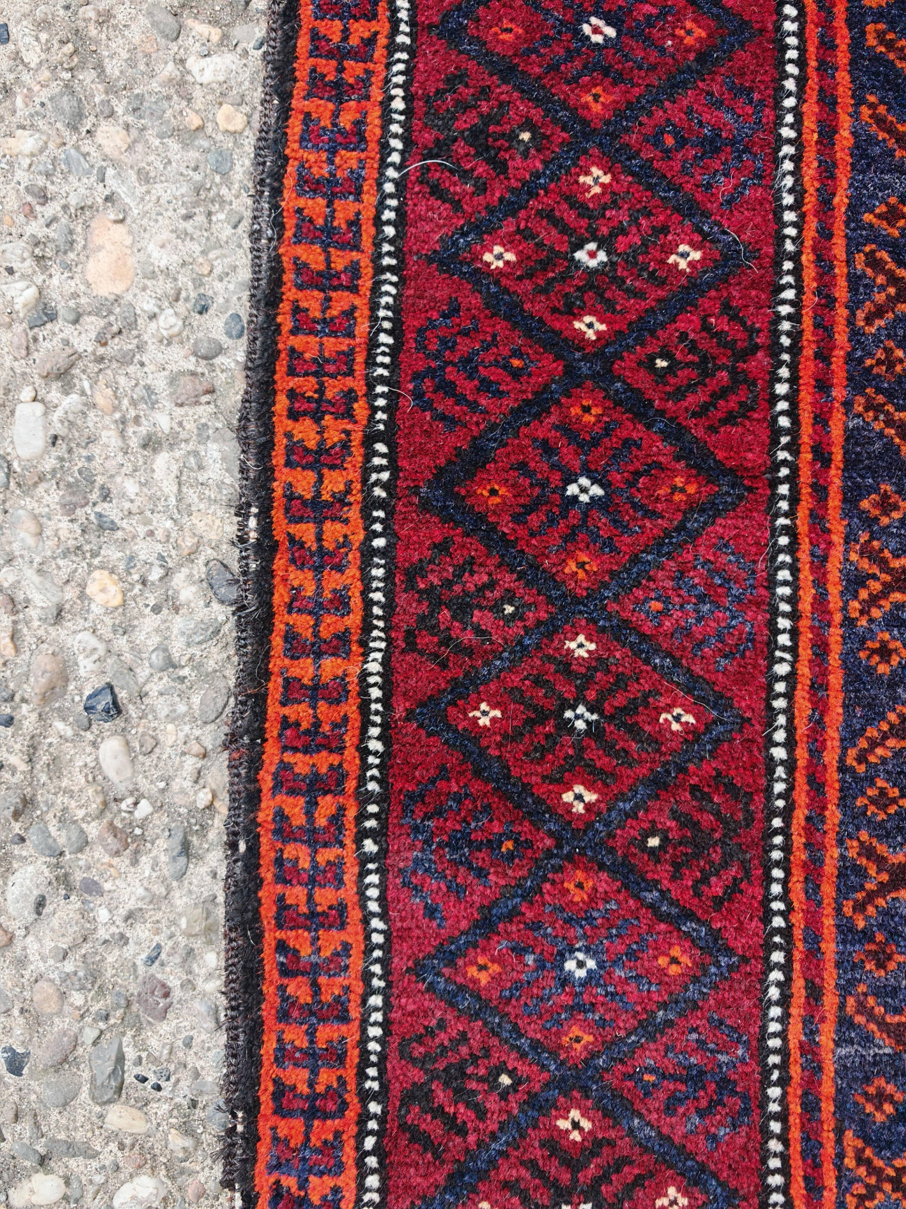 Vintage hand-knotted Persian Baluch prayer rug from the 1940s.