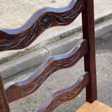 2 solid wood chairs with carved rush seats