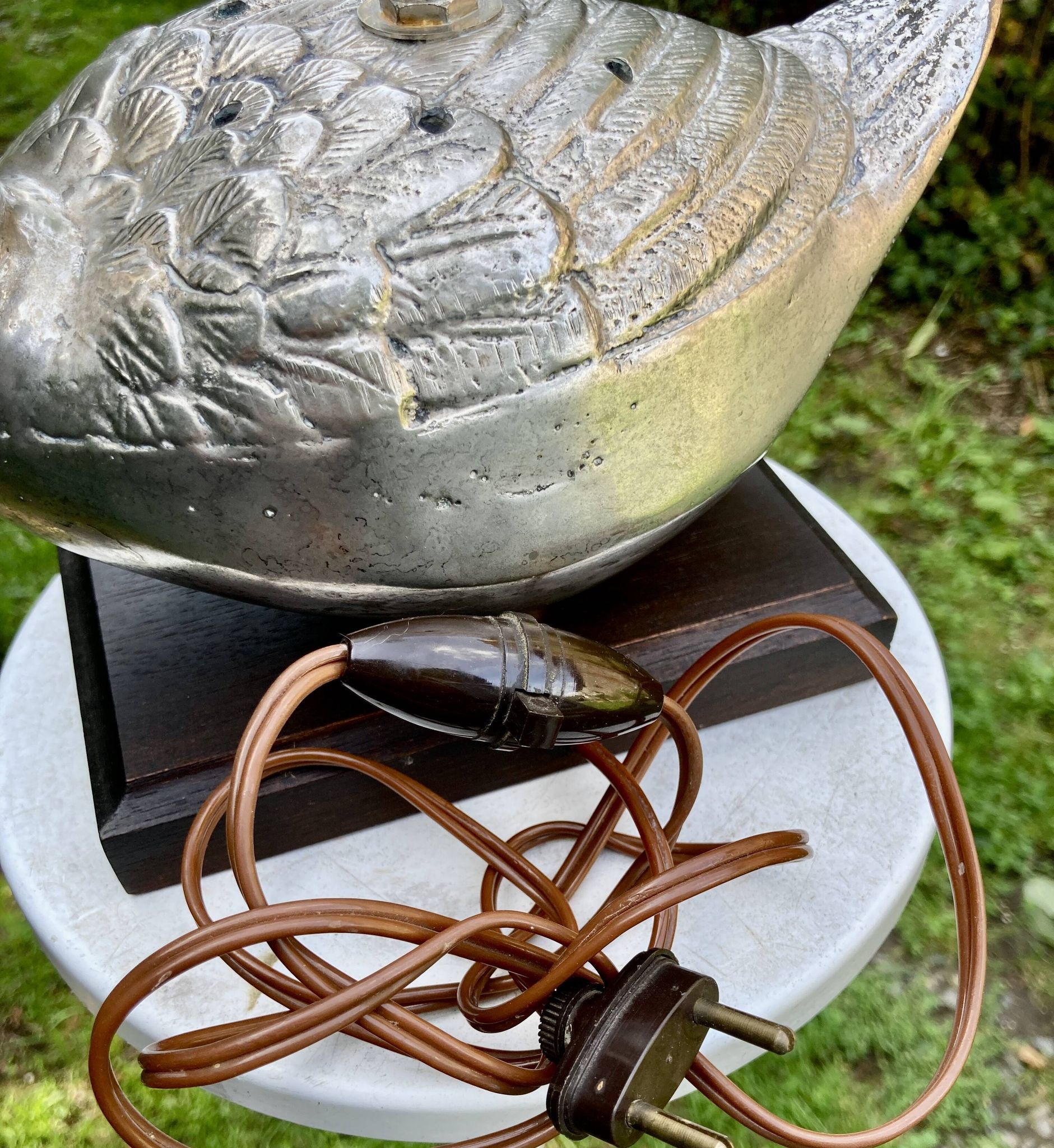 Old vintage lamp representing a duck in silver metal with wooden base