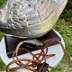 Old vintage lamp representing a duck in silver metal with wooden base