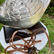 Old vintage lamp representing a duck in silver metal with wooden base