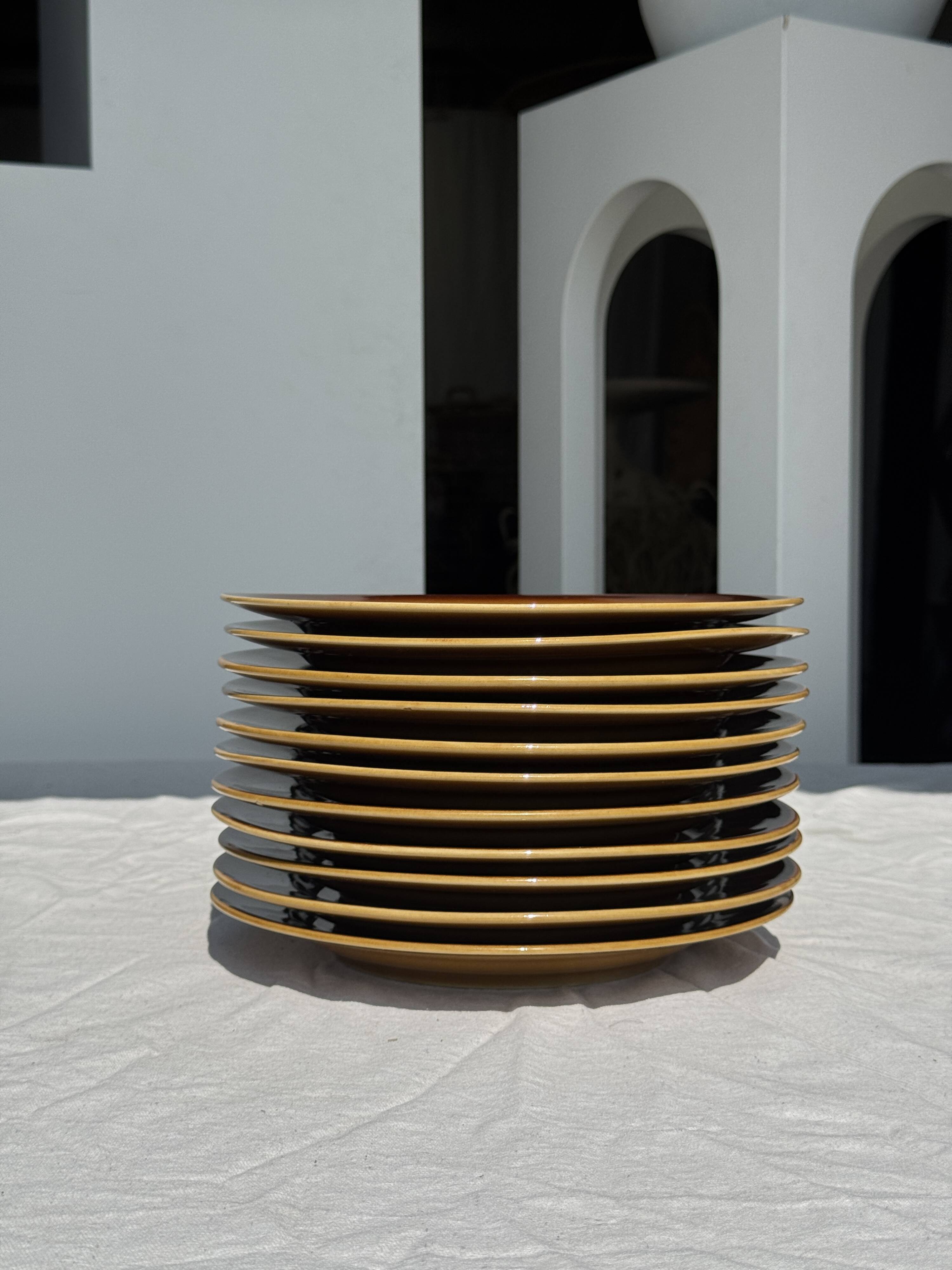 Set of 11 dark brown yellow stoneware plates D24