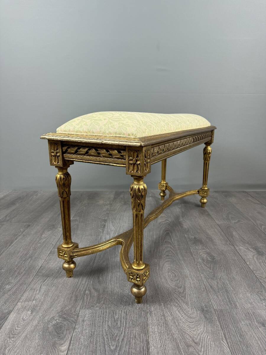 Antique gilded wooden bench in Louis XVI style, 19th century.