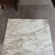 Antique Empire-style bedside table with marble top.