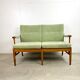 Two-seater sofa from the sixties with green upholstery