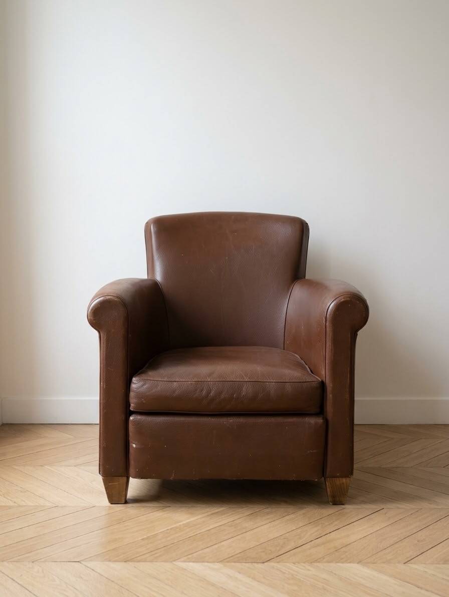 Vintage 1950s armchair in brown faux leather.