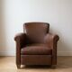 Vintage 1950s armchair in brown faux leather.