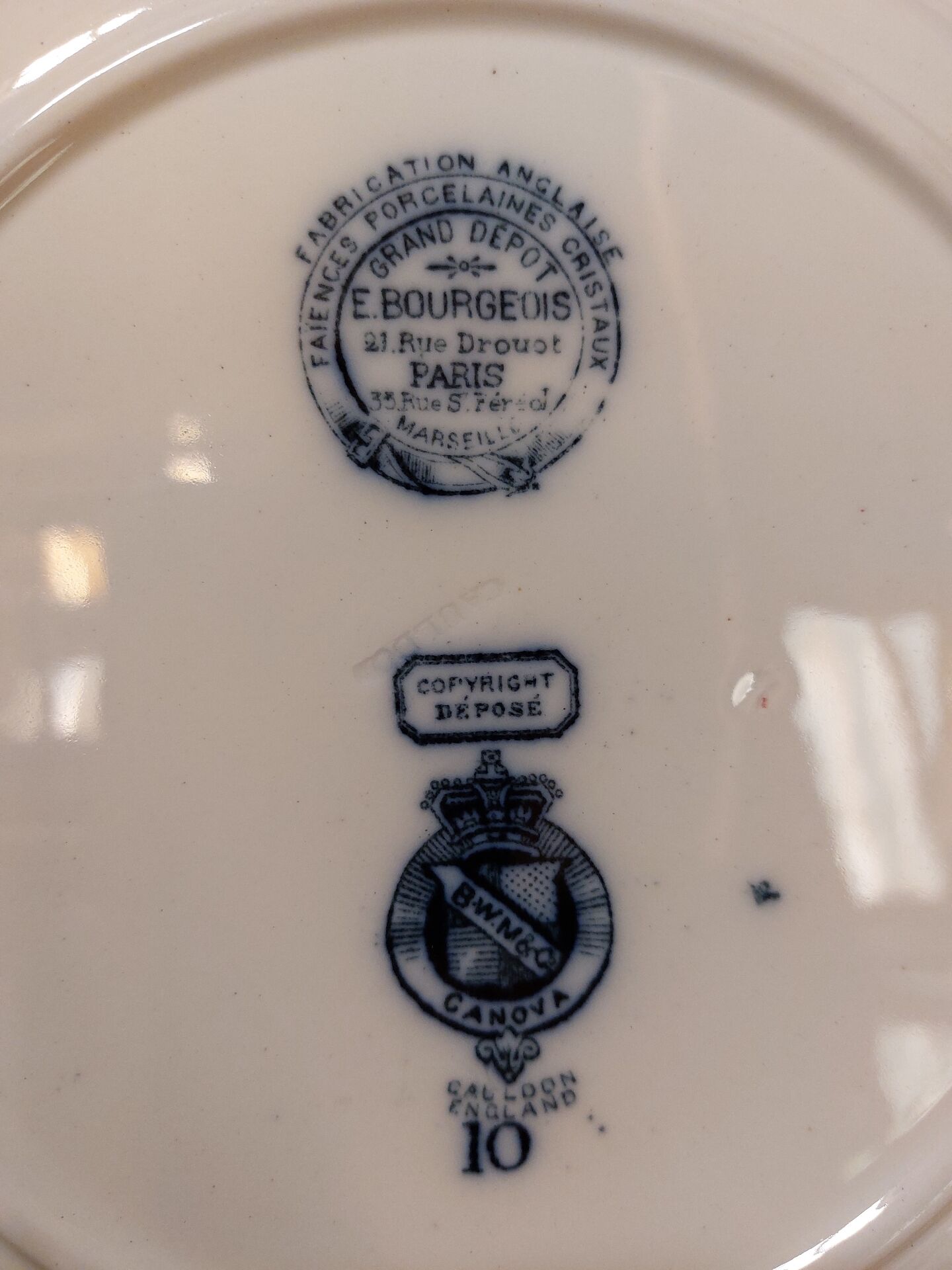 Set of three ironstone plates decorated with birds.