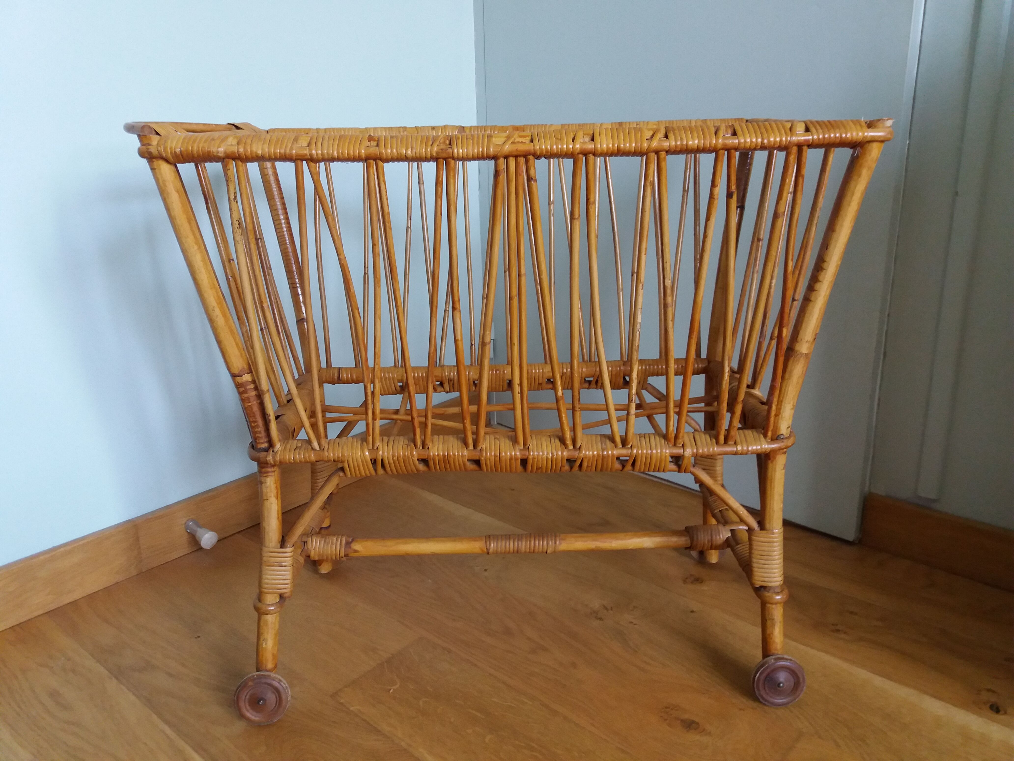 Rattan wicker cradle on wooden wheels