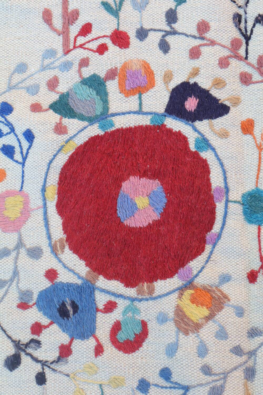 White suzani kilim rug with hand embroidered multi-colored patterns