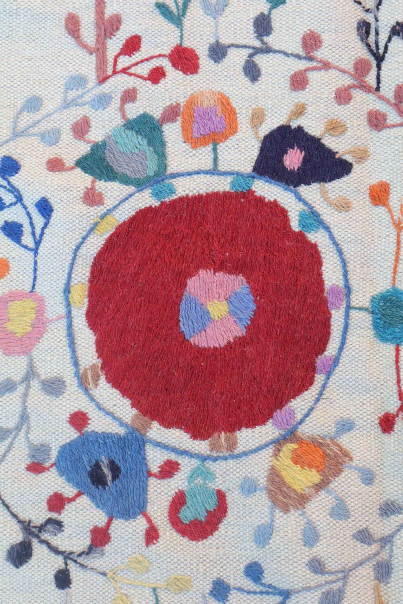 White suzani kilim rug with hand embroidered multi-colored patterns