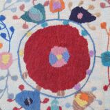 White suzani kilim rug with hand embroidered multi-colored patterns