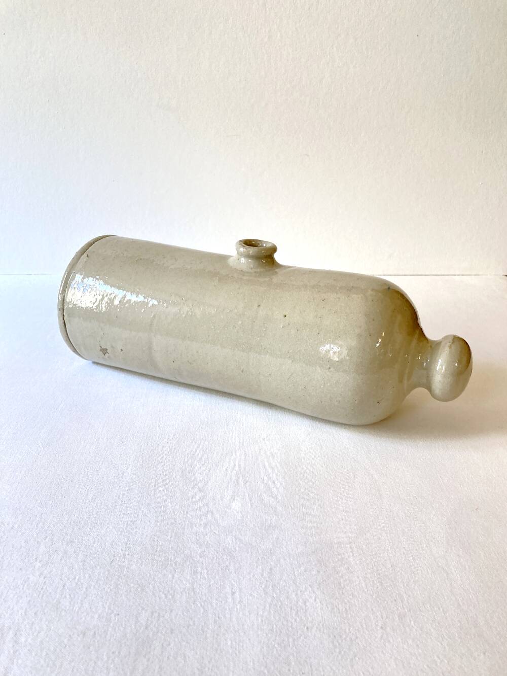 Old horizontal glazed stoneware hot water bottle, late 19th century.