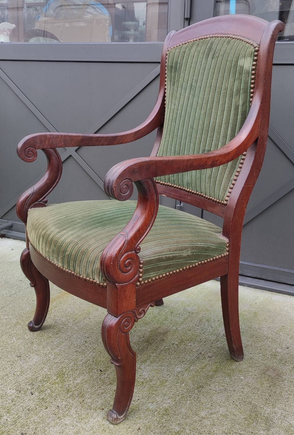 Old green velvet armchair
