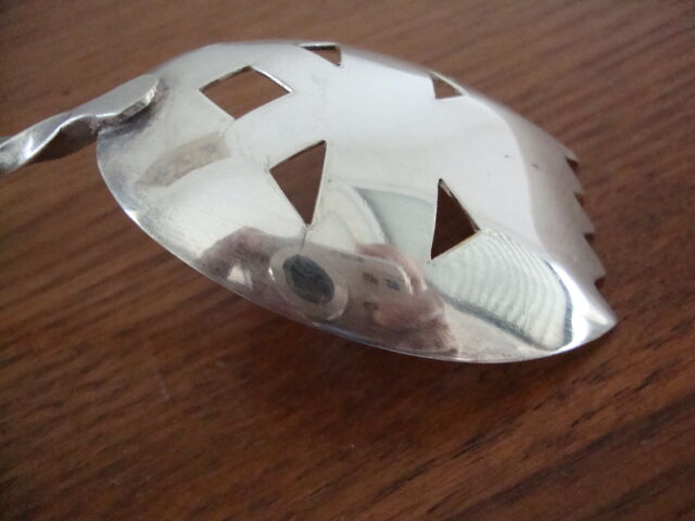 Silver metal sprinkling spoon