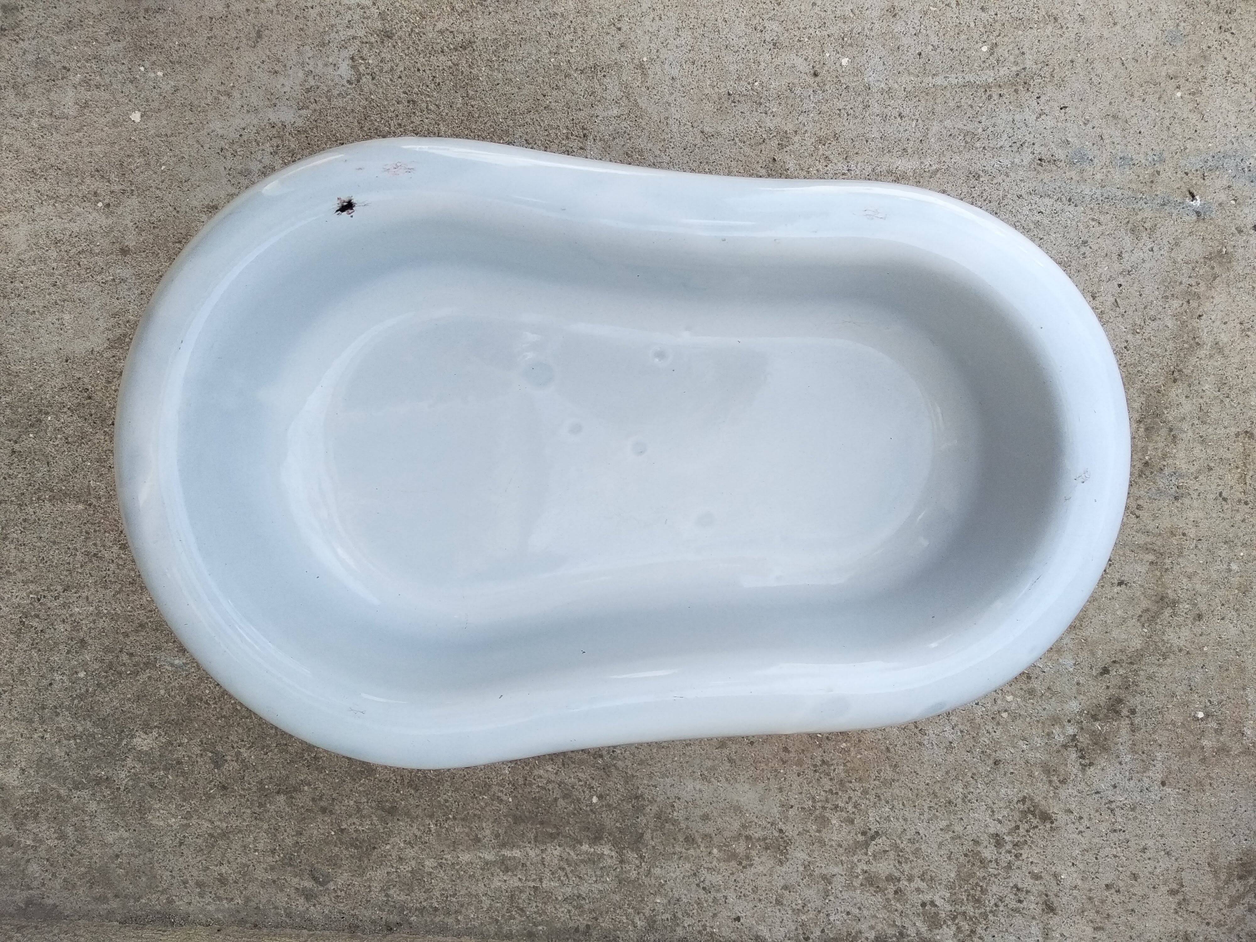 Antique bidet in enamelled sheet metal with wrought iron support
