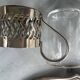 6 small glasses in their silver metal holder, with handle