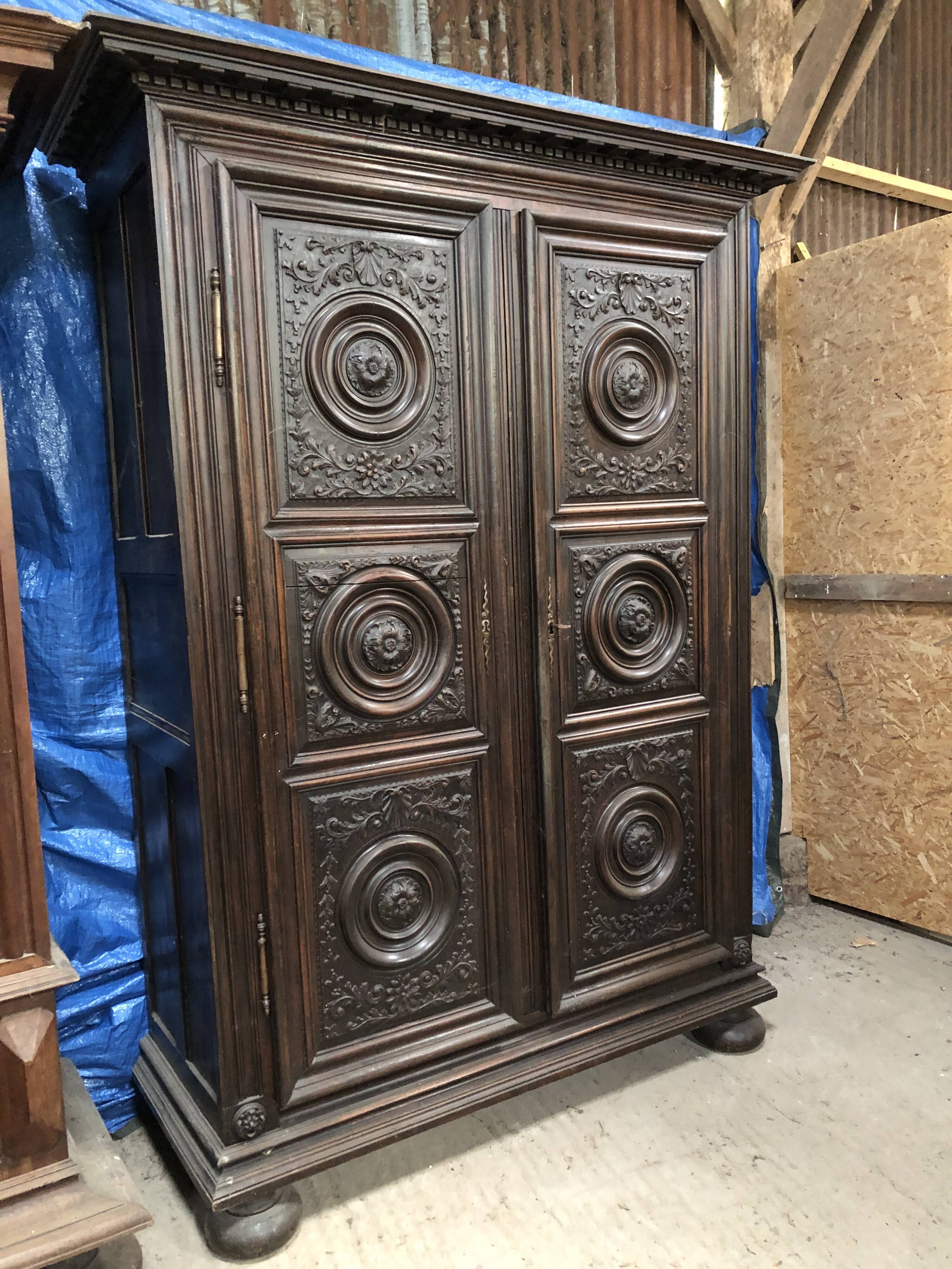 Antique Louis XIII armoire in solid walnut with carved doors