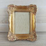 Patinated golden frame in wood and stucco
