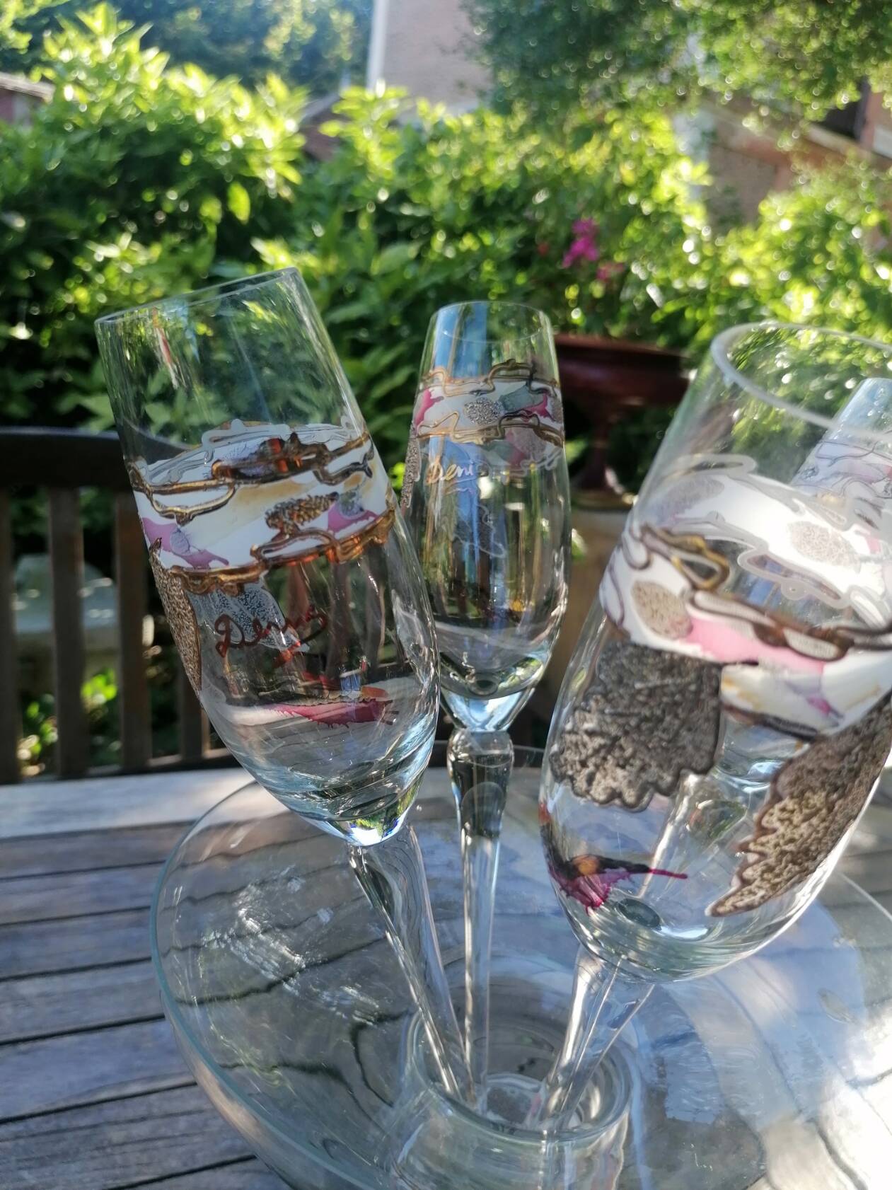 Set of 4 painted blown glass champagne flutes. Signed Denis.