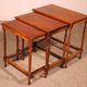 Nested tables in satin wood with brass inlays.