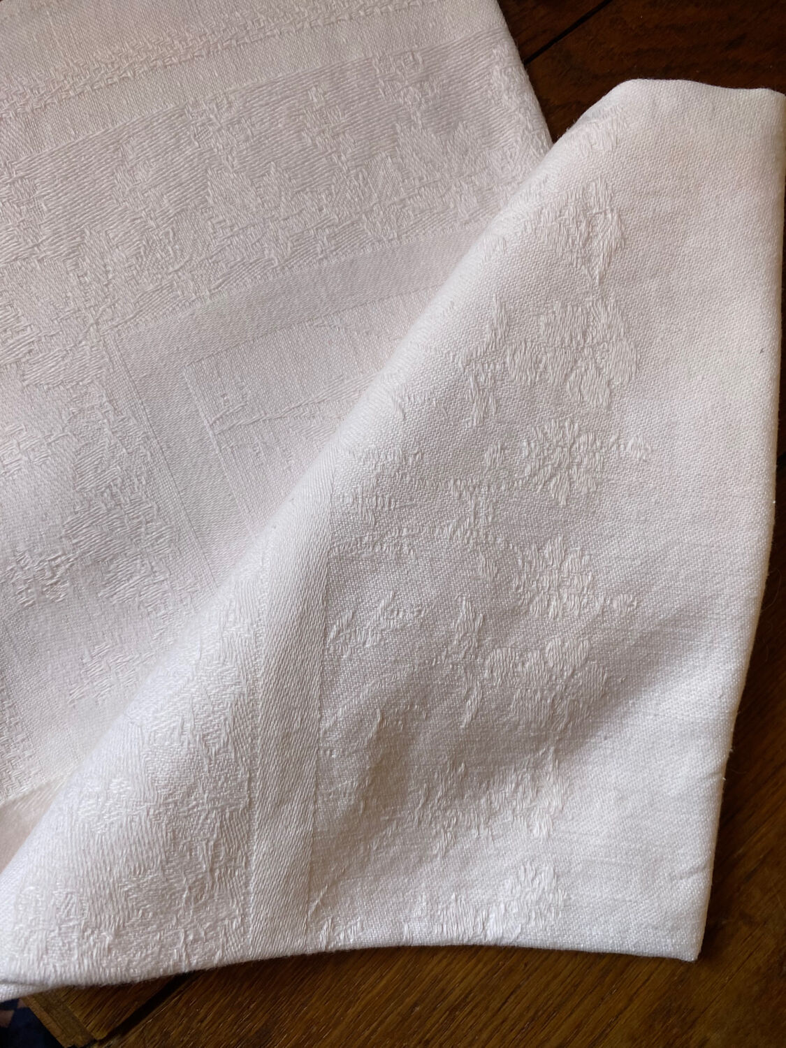 Pair of embroidered white cotton tea towels.