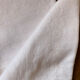 Pair of embroidered white cotton tea towels.