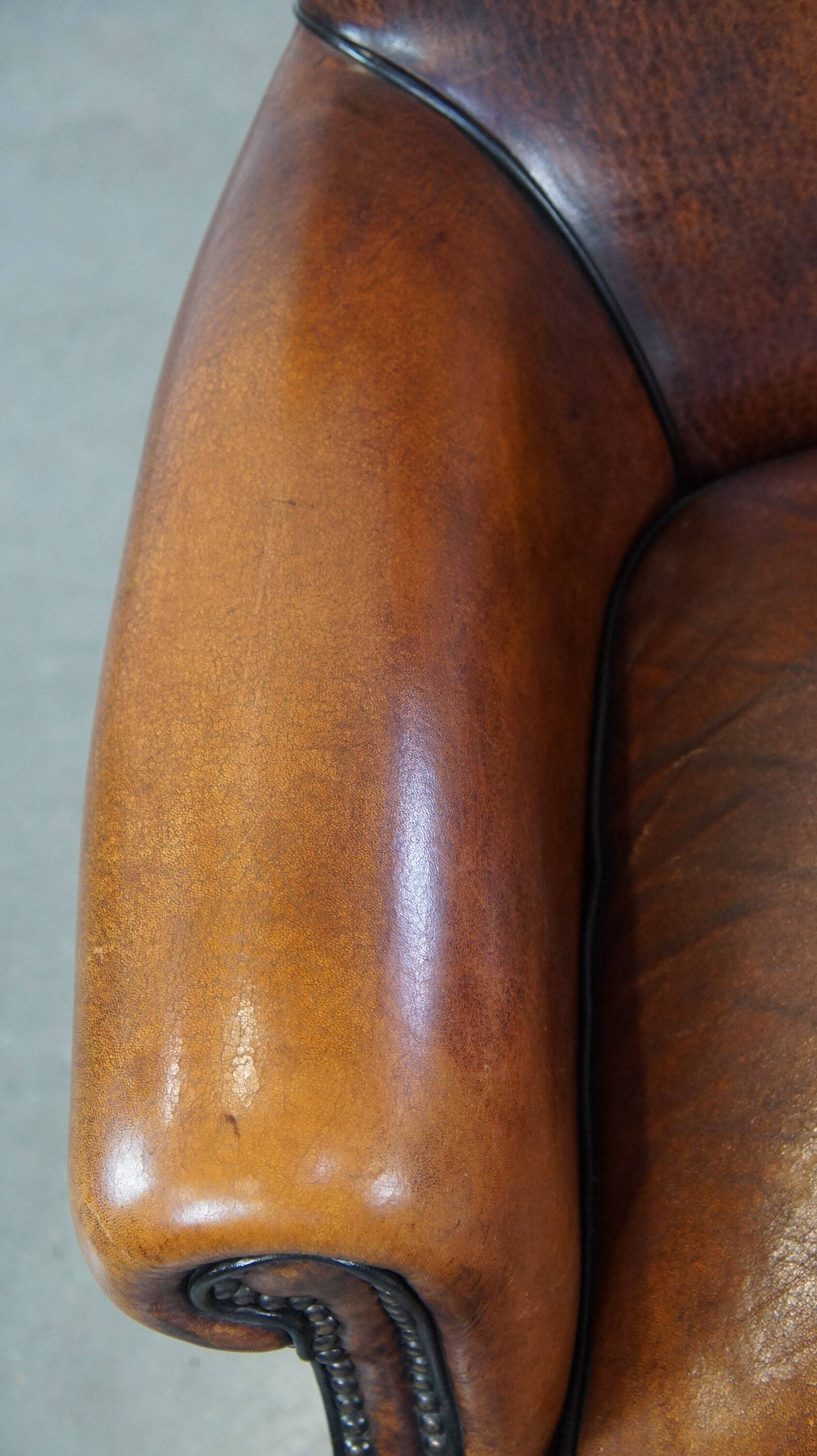 Sheepskin armchair/lounge chair finished with decorative nailheads