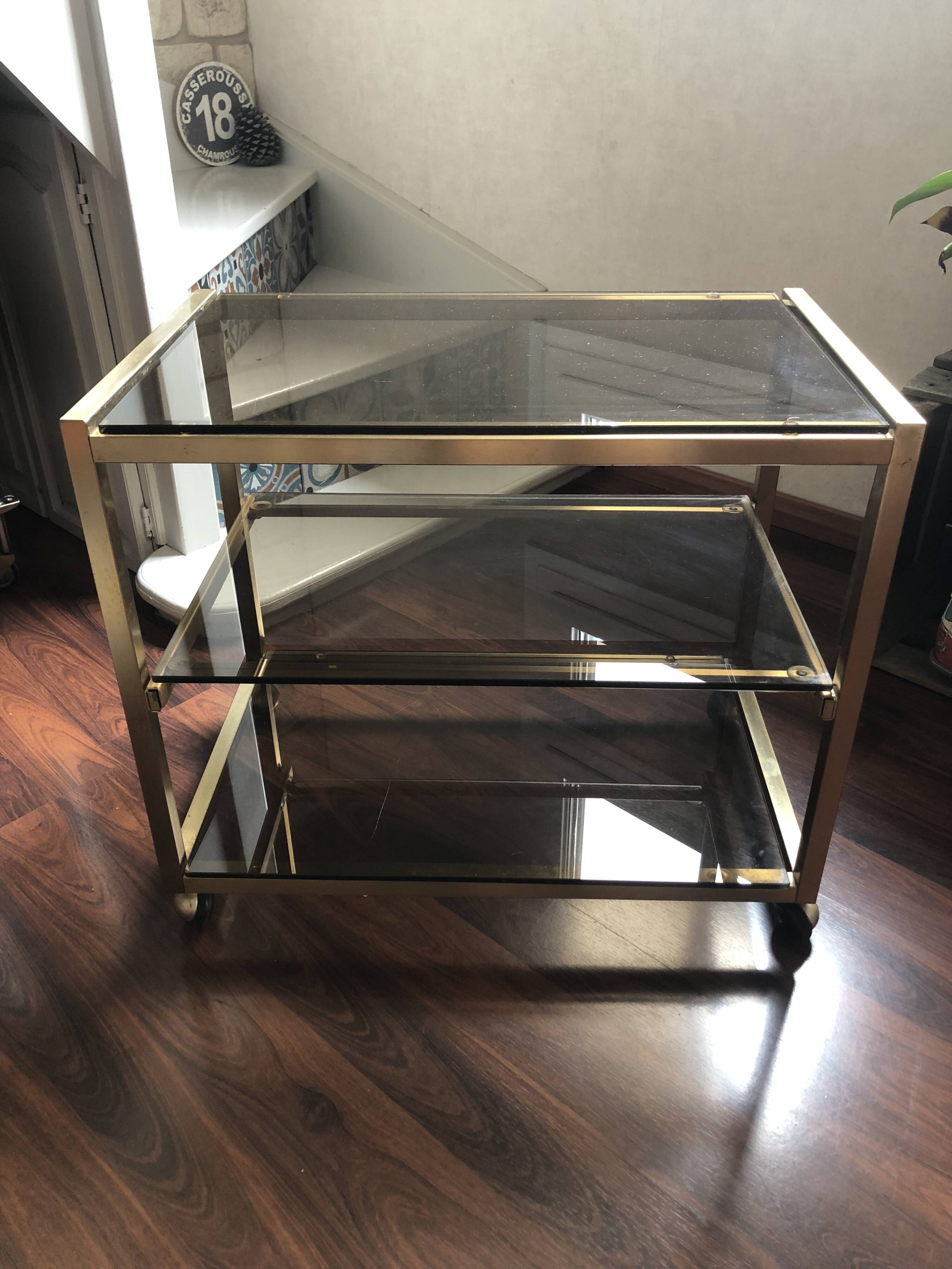Vintage brass serving trolley with smoked glass trays.