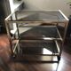 Vintage brass serving trolley with smoked glass trays.