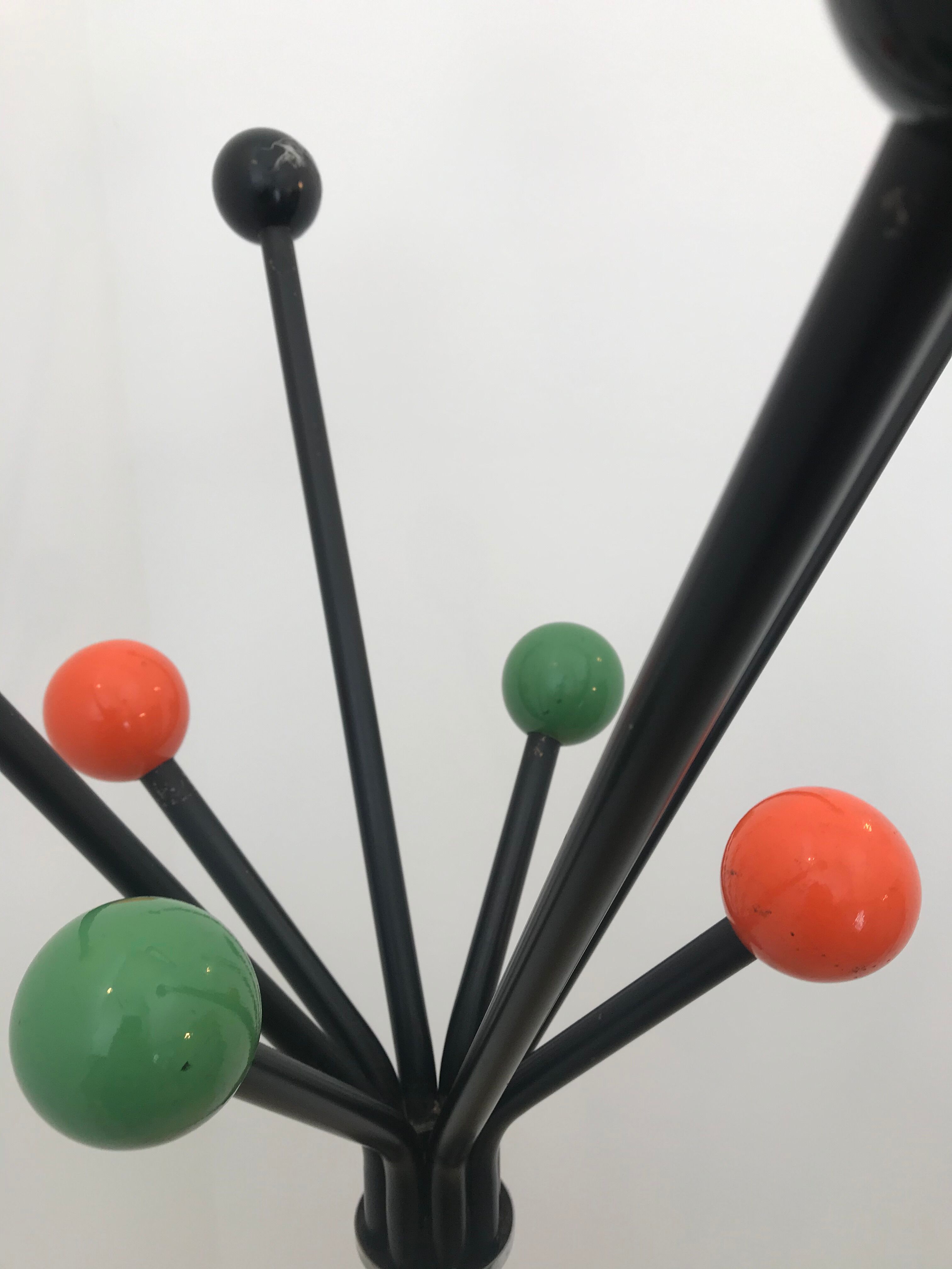 Wearing chrome parrot coat, black and multicolored balls