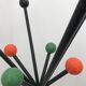Wearing chrome parrot coat, black and multicolored balls